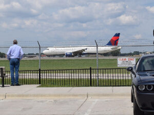 Man watching a plane prepare to take off outside of MSP Airport