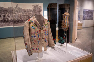 Native American clothing displayed behind glass