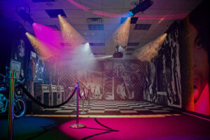 An exhibit at Paisley Park with black and white checkered floor and spotlights