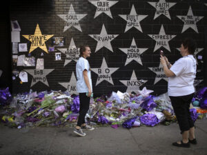 The wall of stars at First Avenue, with a woman taking a photo of her daughter.