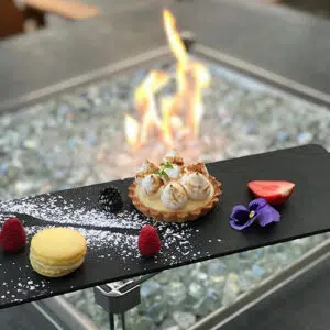 Desserts next to a lit fire pit