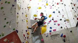 A man looks down from a climbing structure at Vertical Endeavors