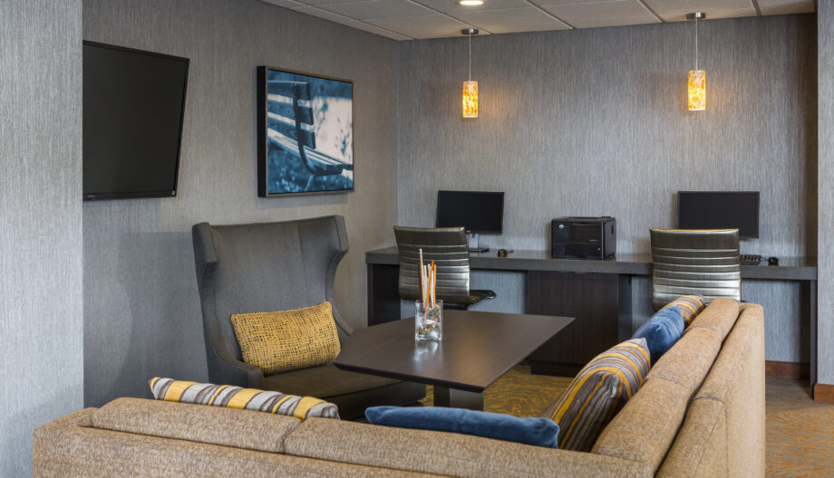 Business center in hotel with seating to watch television