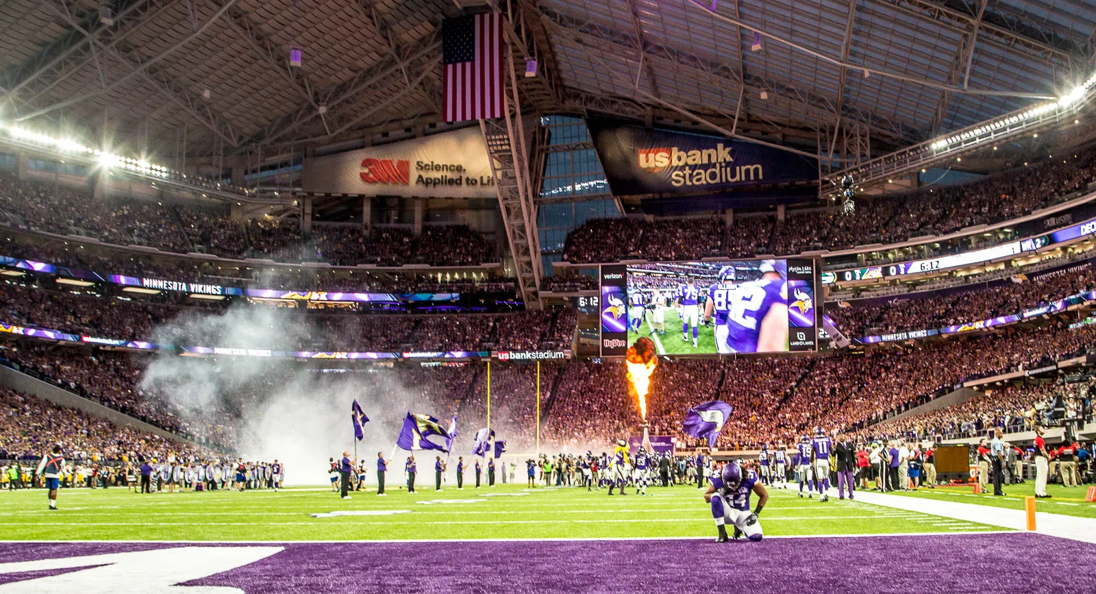 Vikings player kneeling on the field before kickoff