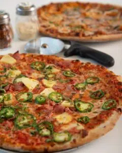 Close-up of jalapeno, pineapple, and Canadian bacon pizza