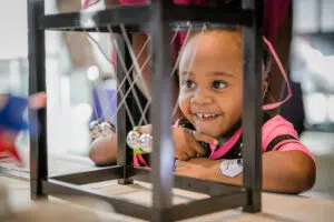 A girl standing in front of an exhibit at Science Museum of Minnesota