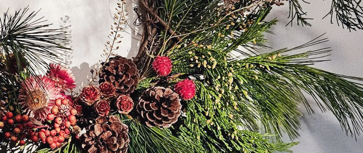 A holiday wreath with pinecones and berries