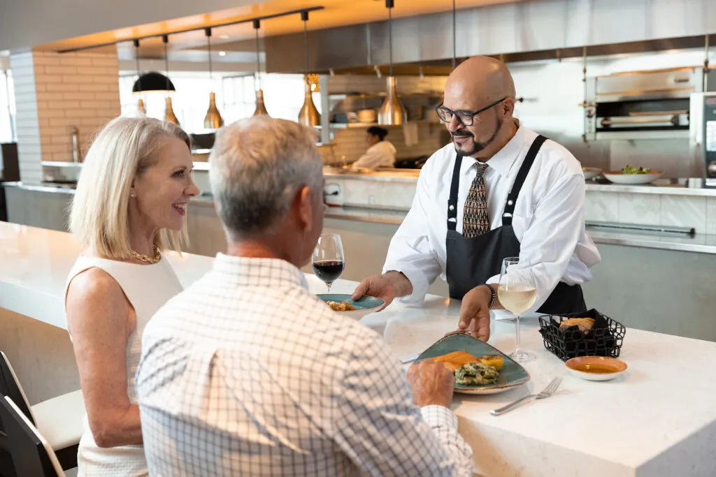 image of couple dining with chef