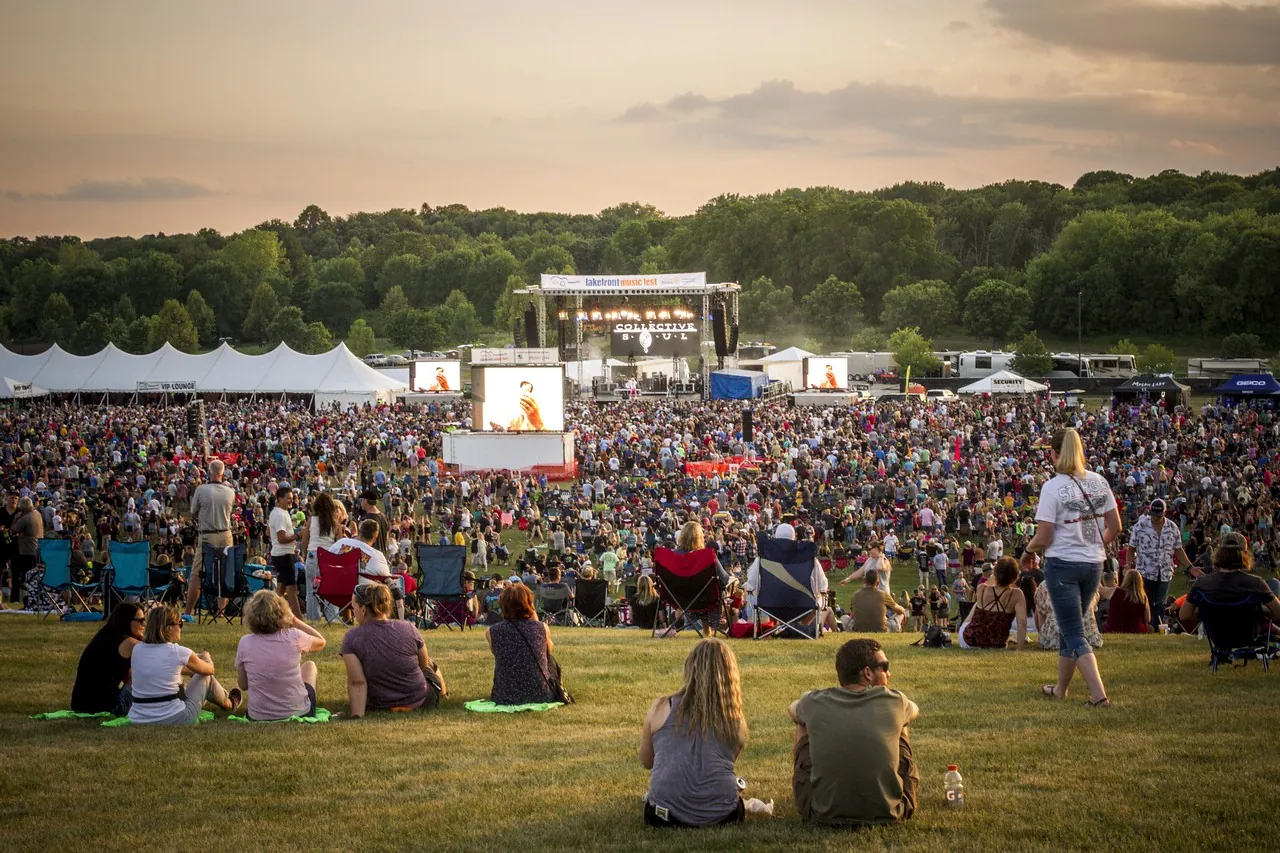 A crowd of people watch a live concert