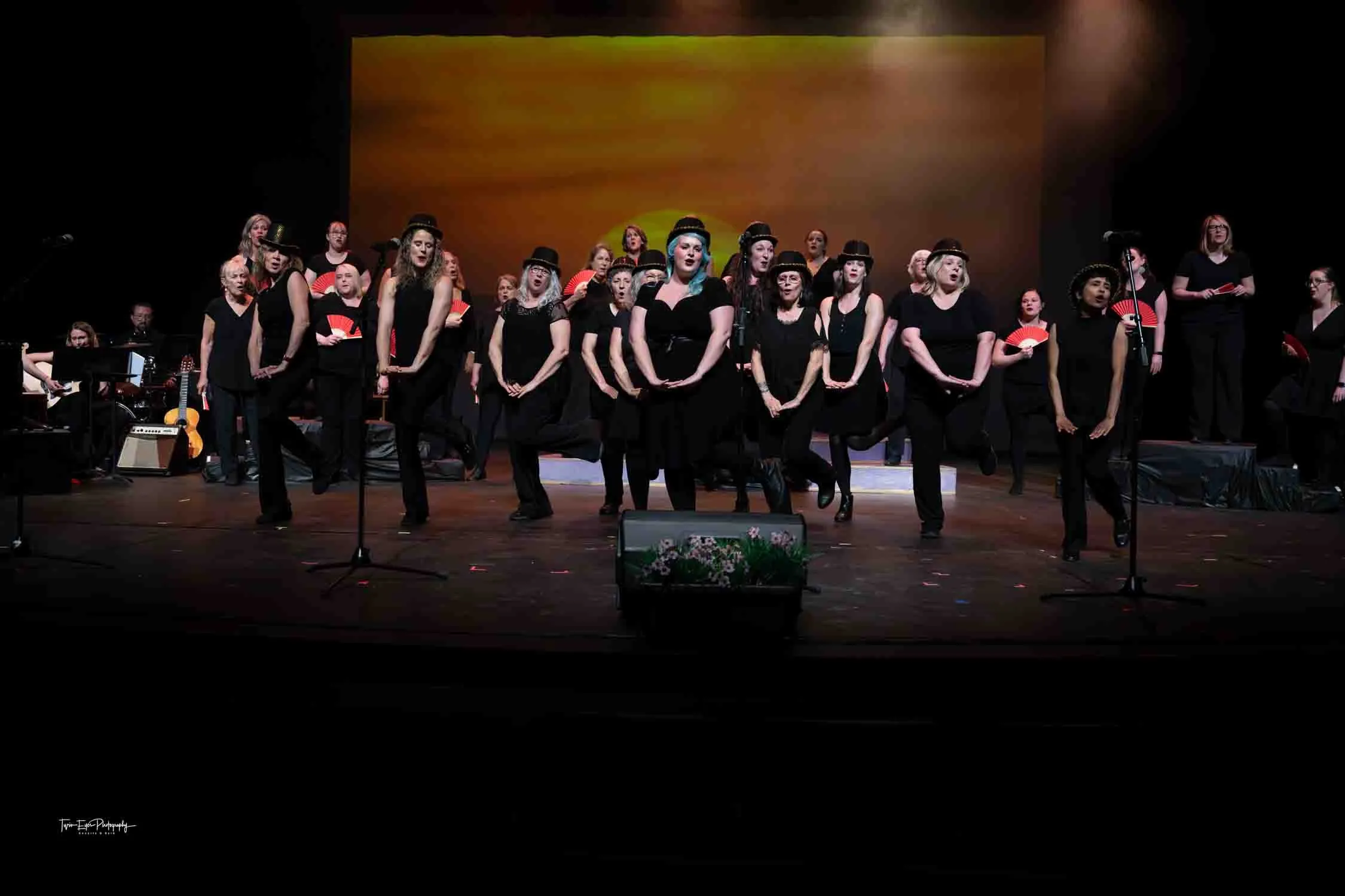 A group of women singers perform on a stage