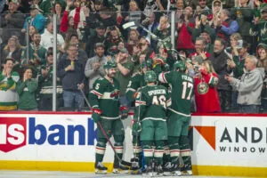 A group of hockey players celebrate a big play