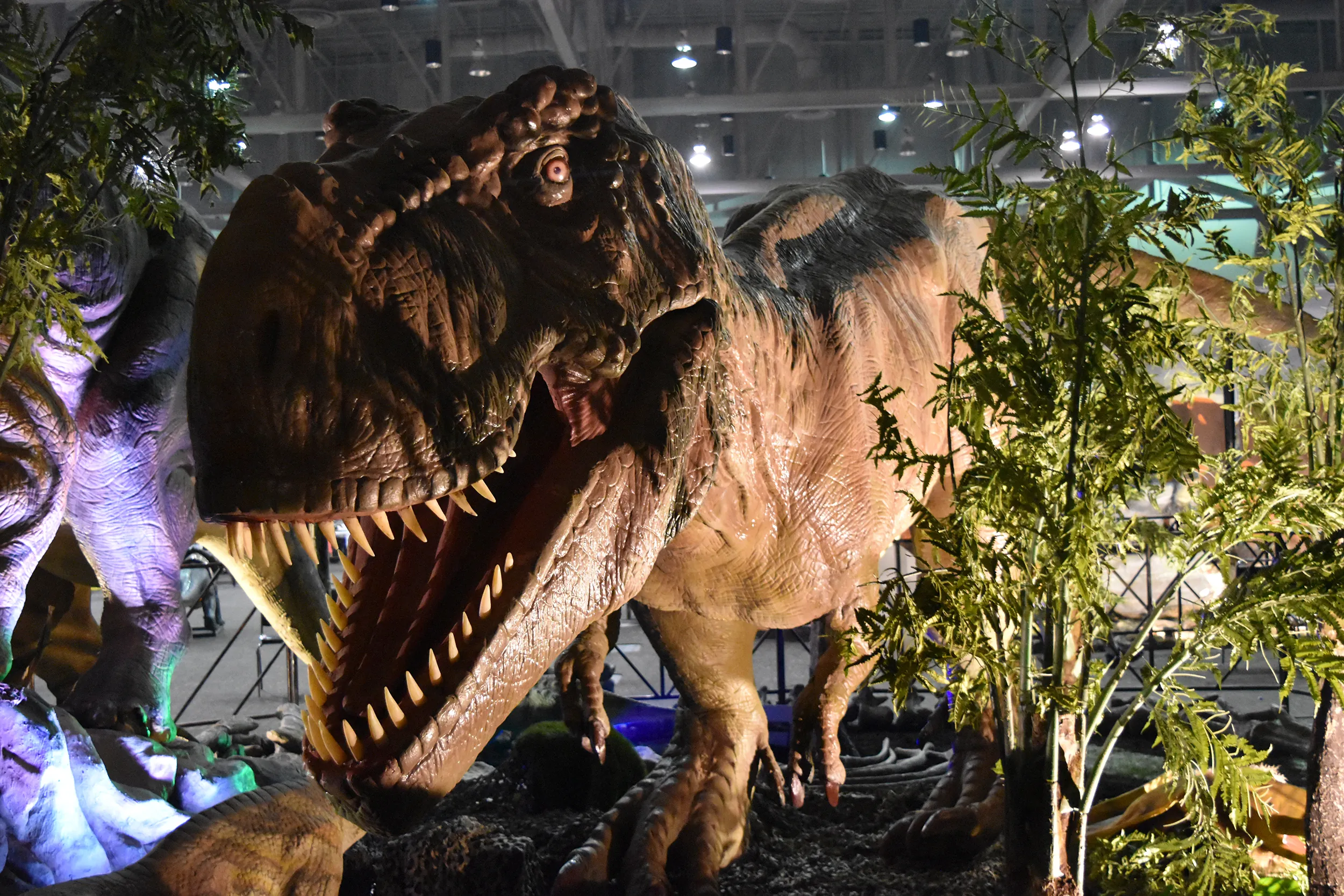 Animatronic dinosaur in front of foliage