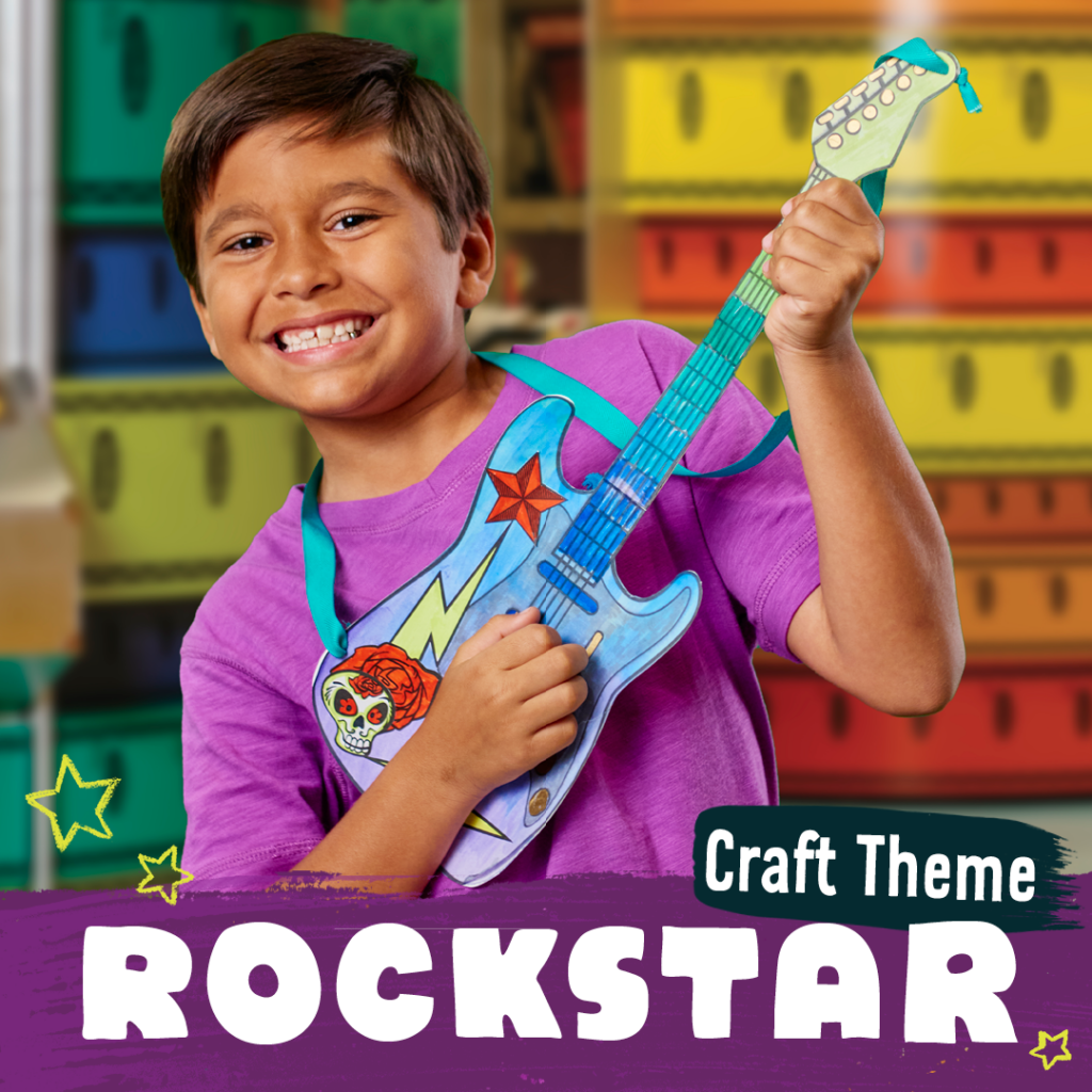 A child holding a paper guitar