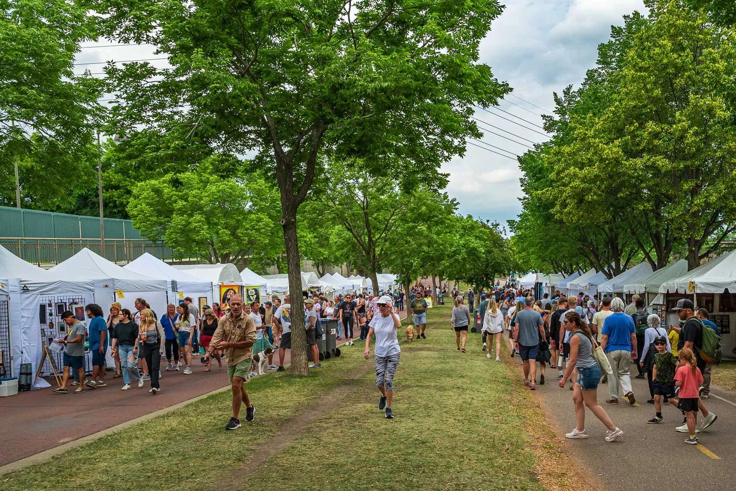 Rows of tents with art for sale at the Stone Arch Bridge Festival