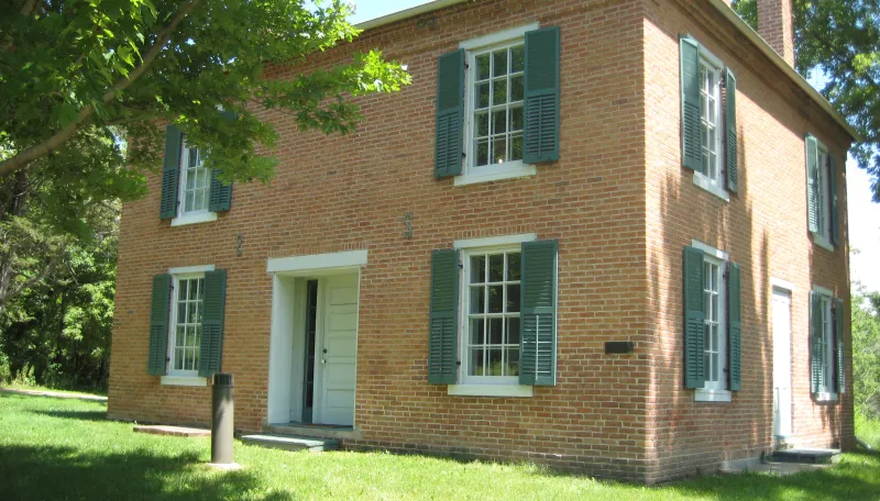 Historic brick home with green shutters